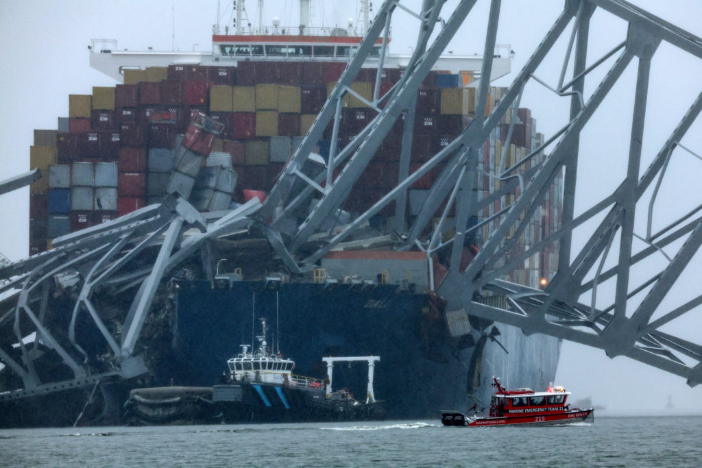A Marine Emergency Team boat boat passes the wreckage of the Dali cargo vessel, which crashed into the Francis Scott Key Bridge causing it to collapse, in Baltimore, Maryland, U.S., March 27, 2024. REUTERS/Mike Segar